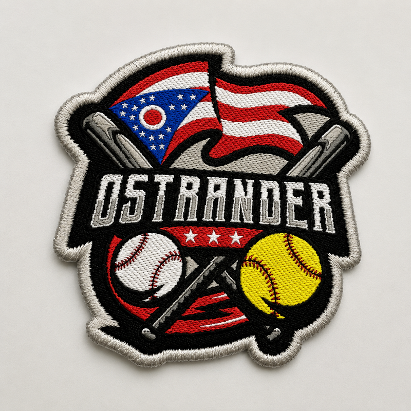 An embroidered baseball patch featuring the name 'OSTRANDER' in white block letters over a black banner, with crossed bats, a red, white, and blue flag, a baseball, and a yellow softball on a light gray background.